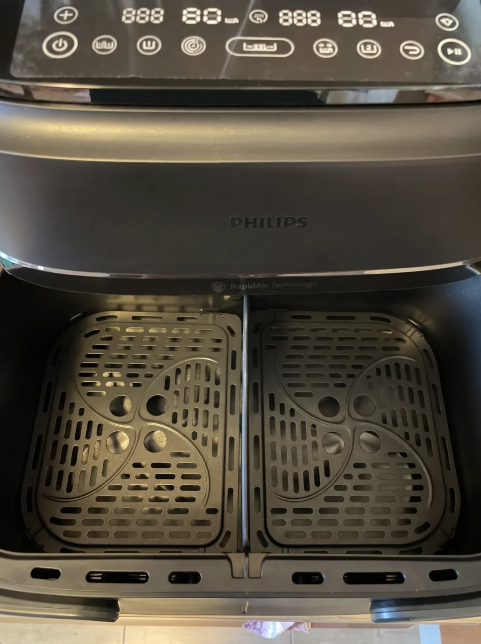 Interno del cassetto con setto divisorio e griglie forate della migliore friggitrice ad aria a doppio cestello modulare Philips